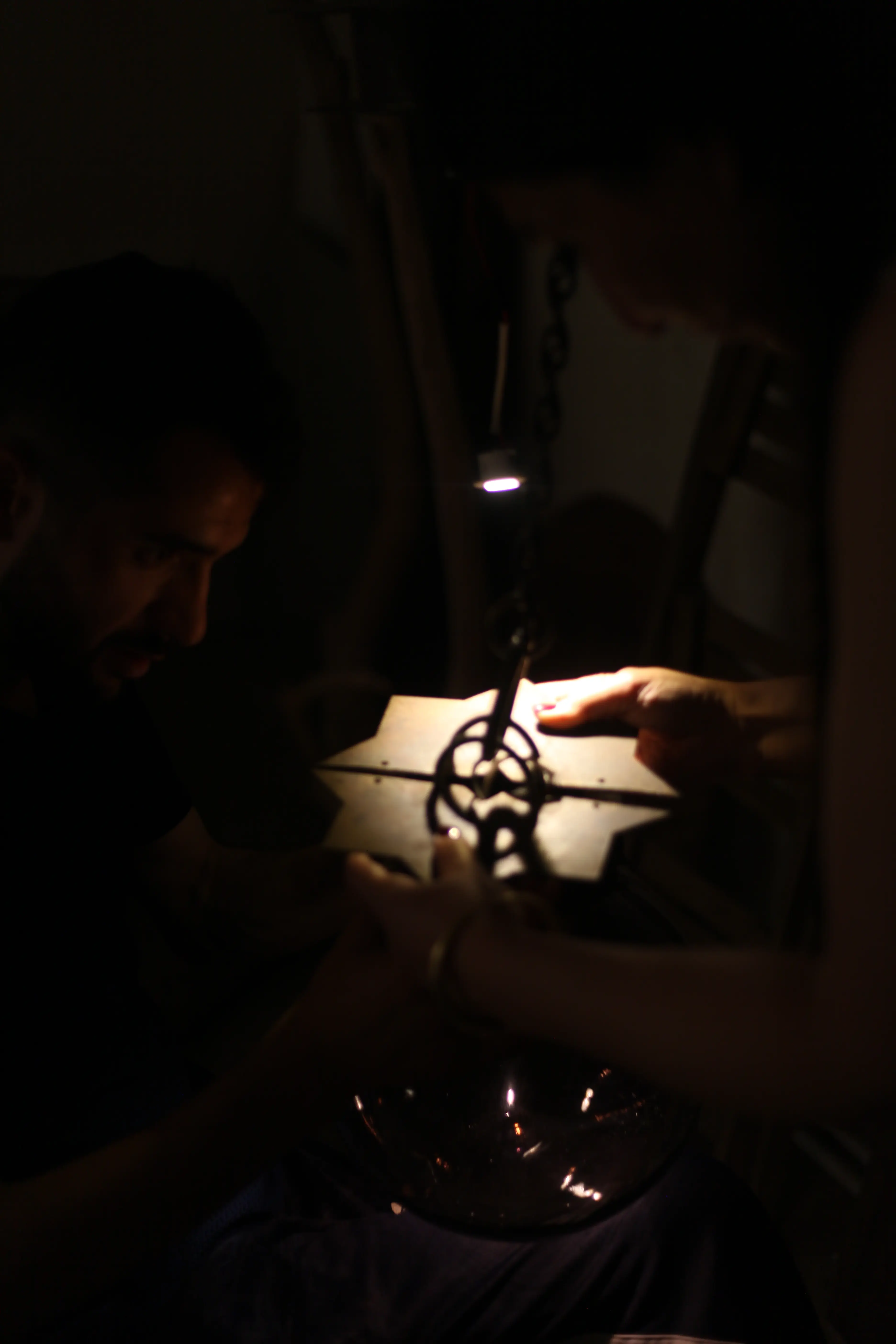 Hands working on a metal piece in the workshop