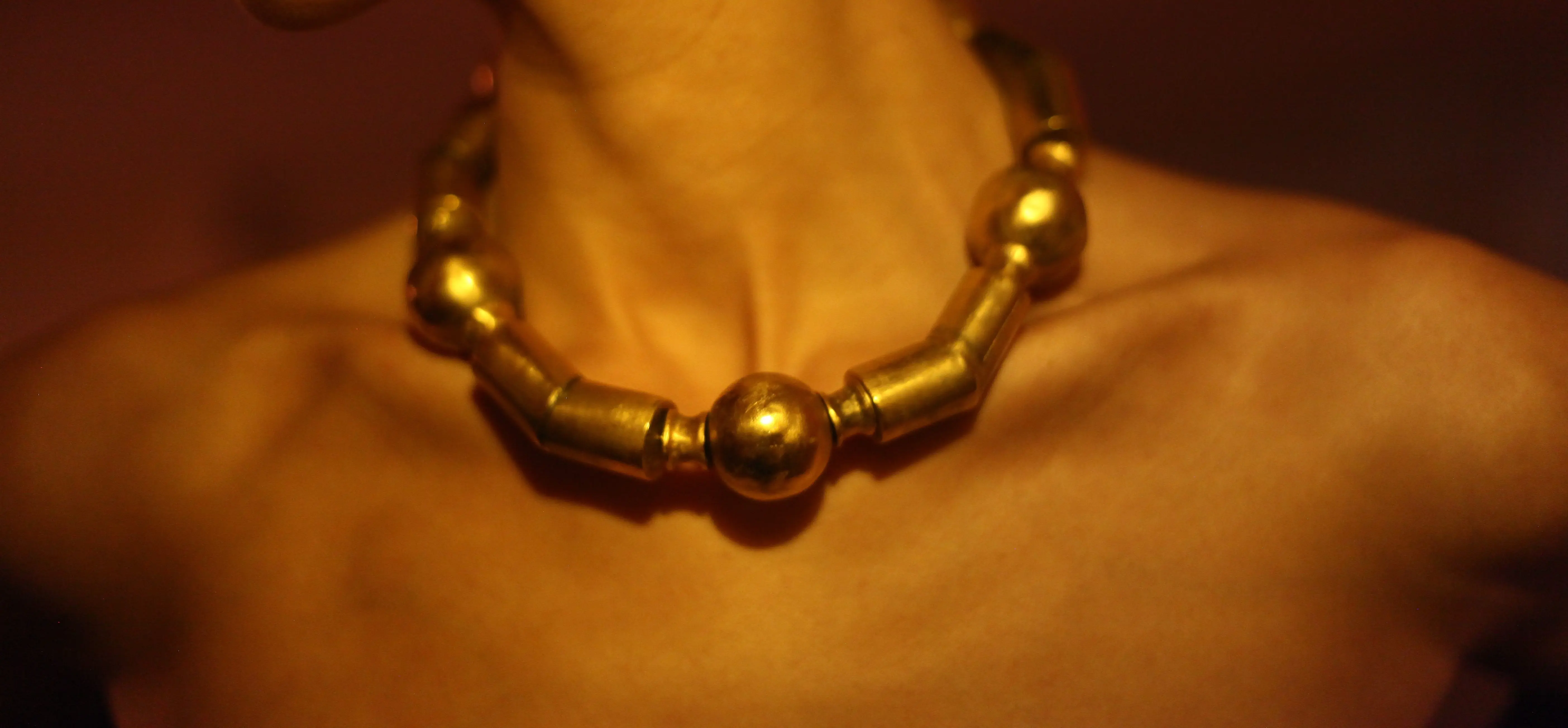 A gold-plated brass necklace from the Hoor collection, worn on the body