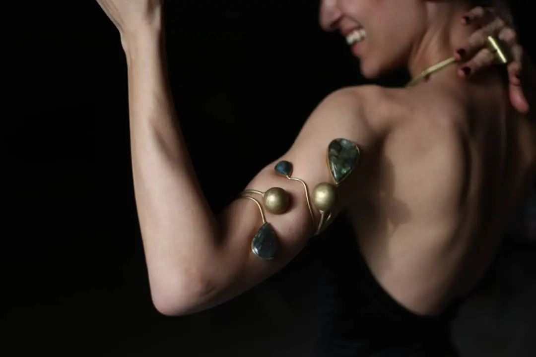 A brass and labradorite arm piece worn on the upper arm